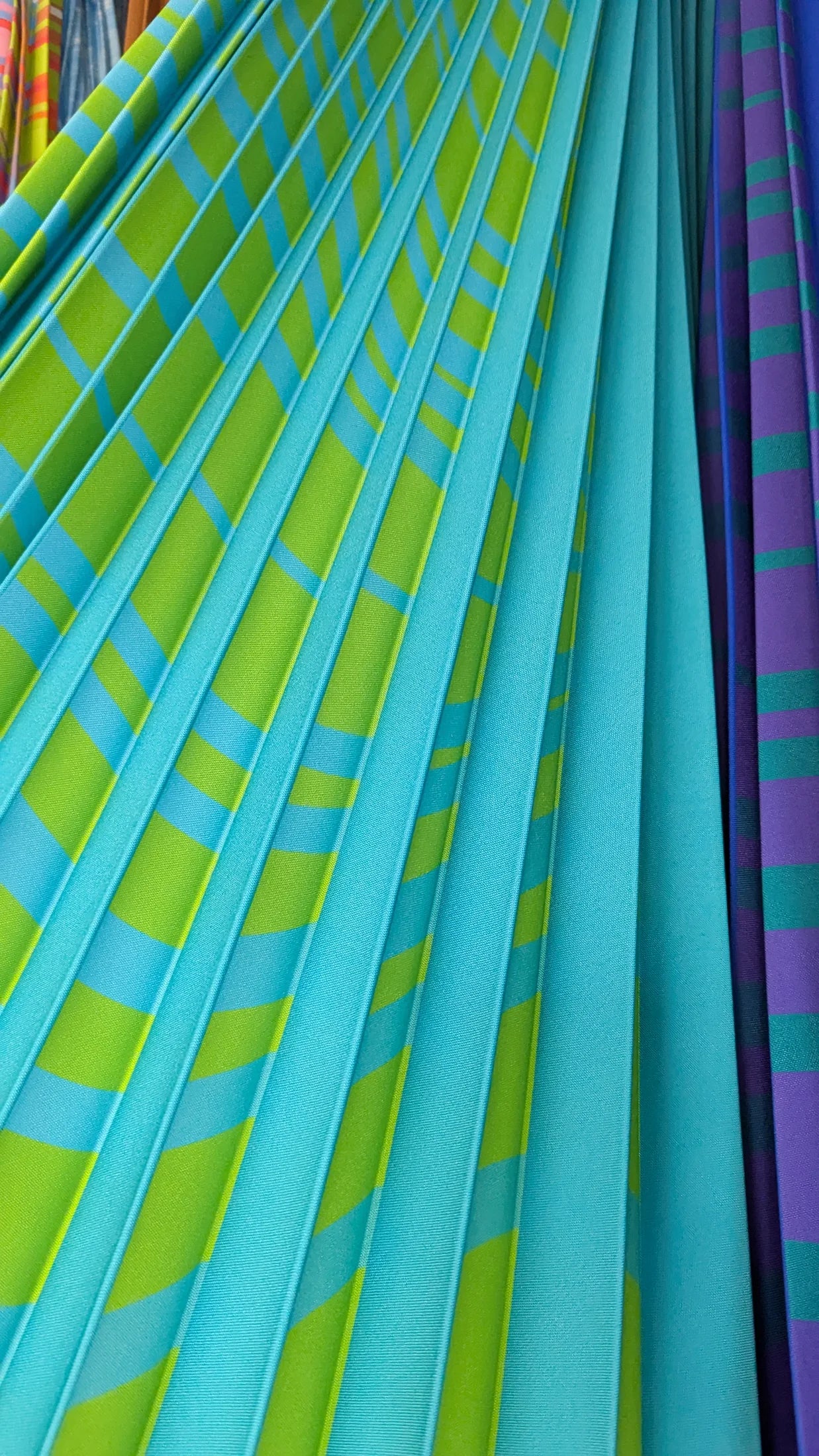 Finished turquoise, green and purple printed pleats