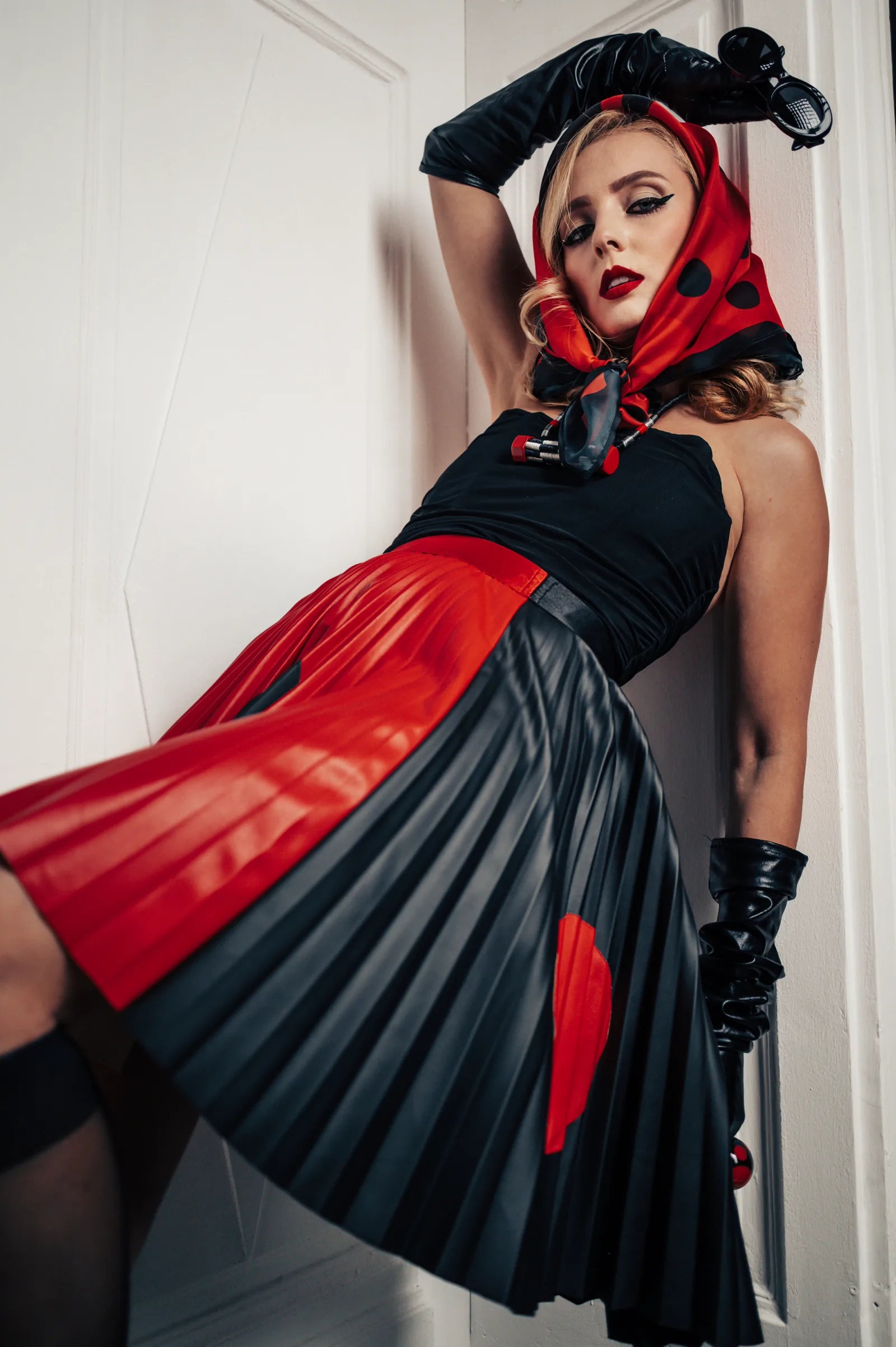 A red and black faux leather pleated skirt