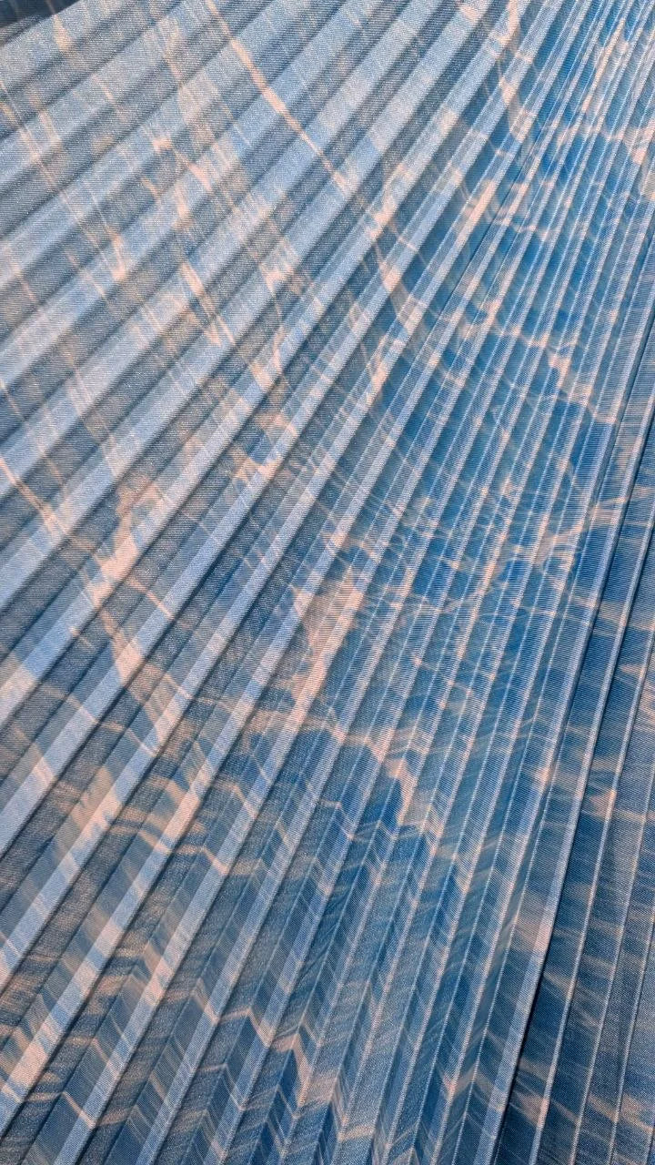 Close view of blue printed satin twill after pleating